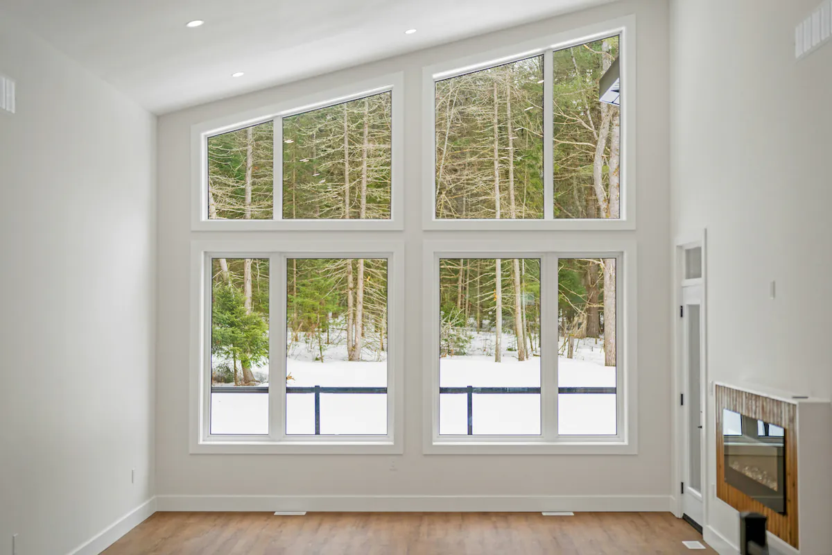 New casement window installed in bright Ottawa living room showing large glass area and slim profile frame